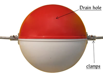 Drain holes in red/white obstruction marking sphere.